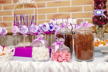 Dessert table at kids birthday party. Cake, candies, marshmallows, cakepops and other sweets