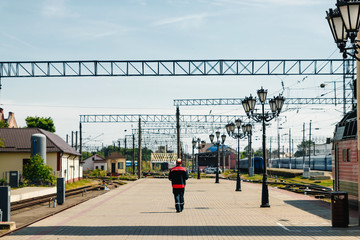 Railway Workers loosening railway on hot summer day