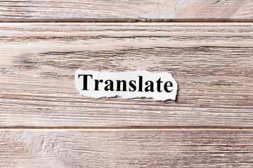 Translate of the word on paper. concept. Words of Translate on a wooden background