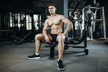 Fototapeta na wymiar Handsome model young man working out in gym
