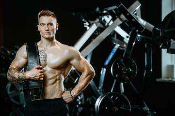 Fototapeta na wymiar Handsome model young man working out in gym