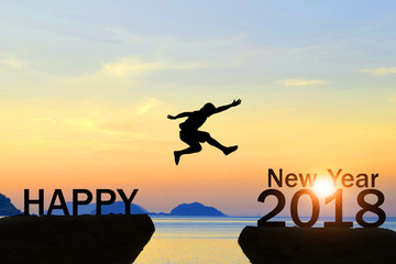 Men jump over silhouette Happy New Year 2018