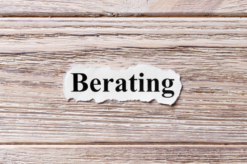 berating of the word on paper. concept. Words of berating on a wooden background