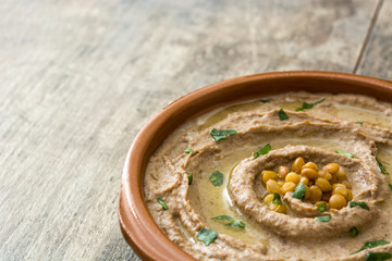 Close up lentil hummus in bowl on wood.Copyspace