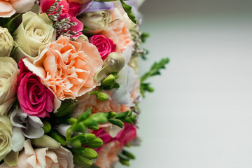 Gold wedding rings on the wedding bouquet of the bride