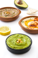 Different hummus bowls. Chickpea hummus, avocado hummus and lentils hummus isolated on white background