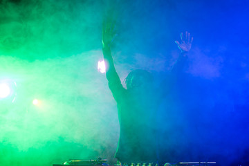Obraz na płótnie Canvas DJ in nightclub with back light