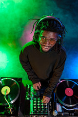 Obraz na płótnie Canvas DJ with sound mixer in nightclub