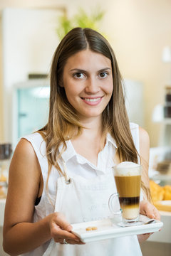 Waitress carrying drink, portrait