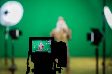 Shooting the movie on a green screen. The chroma key. Studio videography. Actor in theatrical...