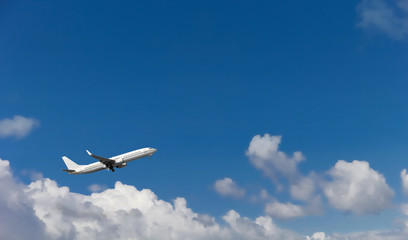 Commercial airplane landing at the airport with cloudy sky in the background. Copy space in the...