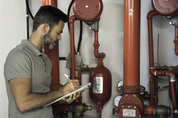 Man inspecting fire protection sprinkler system