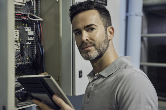Man working in electrical control cabinet