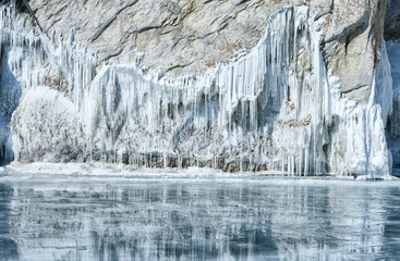 icicles and ice outgrowths on the rock of lake Baikal