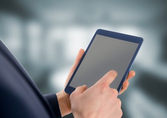 Person holding tablet with office background