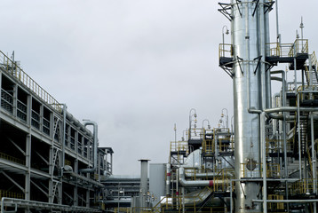 Section of the distillery plant of a modern oil refinery with a fractionating column, tanks and...