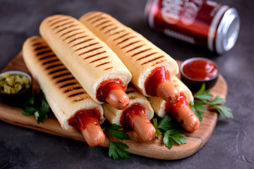 French hot dog with ketchup, mustard, mayonnaise and marinated cucumber.