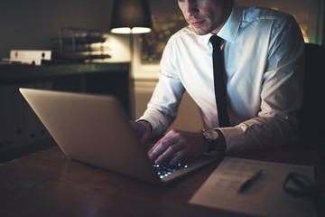 The office worker typing text on laptop