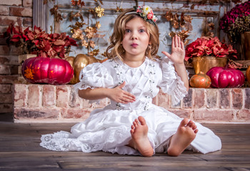 Fototapeta premium Little beautiful girl is playing on the floor. Little Princess