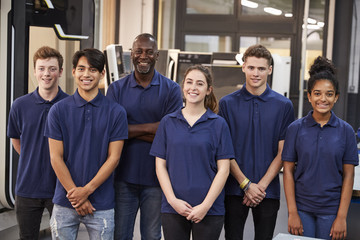 Portrait Of Engineer And Apprentices In Factory - obrazy, fototapety, plakaty
