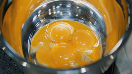 Raw eggs are in metal plate