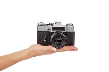 Fototapeta premium Hand holds an old photo camera, isolated