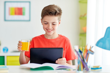 student boy with tablet pc and juice at home © Syda Productions