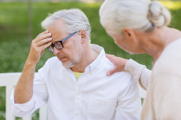 senior man suffering from headache outdoors