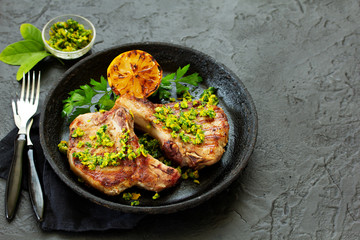 Pork cutlet on a bone with gremolat sauce.