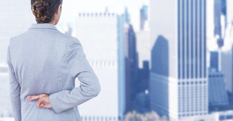 Fototapeta premium Businesswoman crossing fingers in city