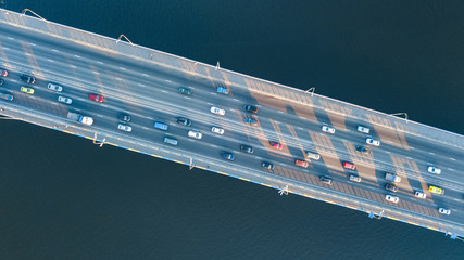 Aerial top view of bridge road automobile traffic jam of many cars from above, city transportation concept
