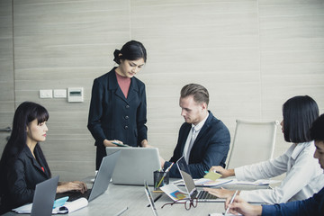 Asian Business Woman presenting her work with team at the meeting room, People working Concept. Vintage Tone.