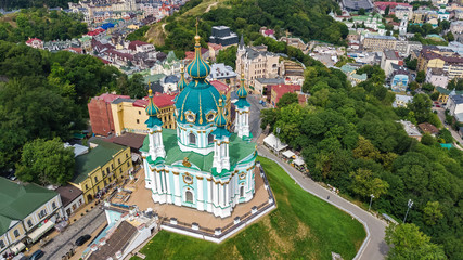 Aerial top view of Saint Andrew's church and Andreevska street from above, cityscape of Podol...