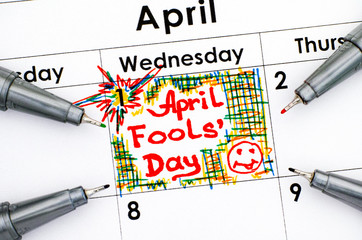 Reminder April Fools Day in calendar with four pens.