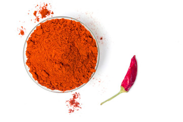Ground red pepper in a bowl isolated