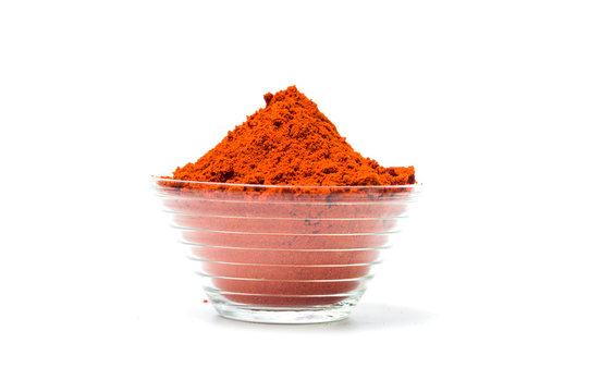 Red pepper powder in a bowl isolated