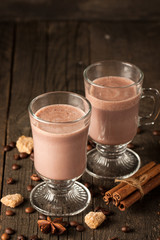 Chocolate, coffee, milk, banana shake on wooden background. Smoothie with cookies. Milkshake. Protein diet. Healthy food concept.
