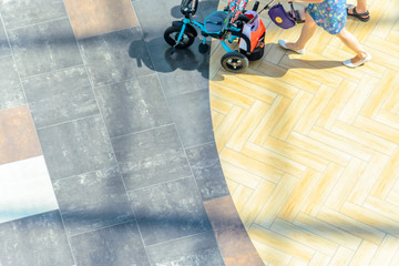 Woman with a baby stroller, top view. Blur in motion, abstract background with blank space for text placement