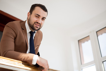 Portrait of successful businessman in hallway. Business and communication