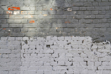 Light and dark grey brick wall with sunlight as background, texture