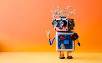 Fotobehang Friendly crazy robot handyman on orange background. Creative design cyborg toy. Copy space photo © besjunior