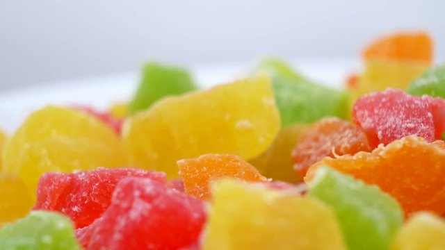 Turkish Delight. Closeup concept as Background. Rotates plate with colorful cubes candied fruit on white background