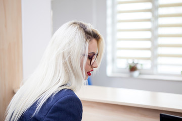 Business lady in the waiting are looking at secretary next to two employees