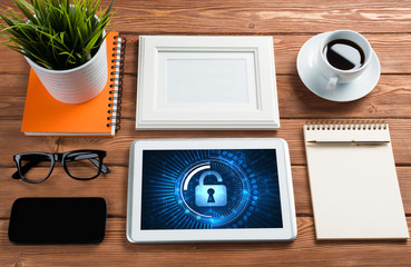 Web security and technology concept with tablet pc on wooden table