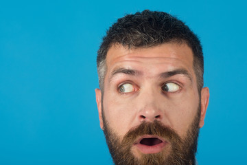 man with beard on scared face on blue background
