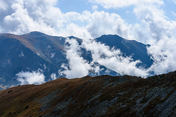 mountain tops in  autumn covered in mist or clouds