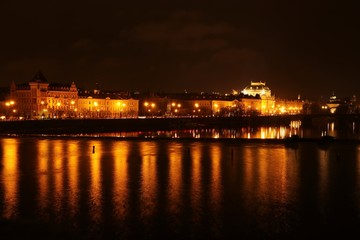 Fototapeta na wymiar Prague at night , panoramic night view from Charles bridge to the illuminated national theatre