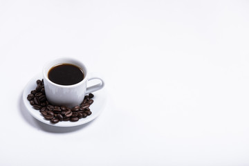 cup of coffee on a white background, scattered coffee beans, heart made of coffee beans, morning coffee at home