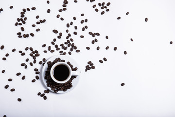cup of coffee on a white background, scattered coffee beans, heart made of coffee beans, morning coffee at home