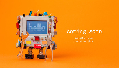 Web site under construction Coming Soon template page. Toy robot with hand wrench and pliers. Orange background - 181166218